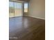 Well-lit living room highlighting wood-look flooring and sliding glass doors at 24638 N 65Th Ave, Glendale, AZ 85310
