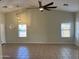 Bright living room with tiled floors, high ceilings, and modern lighting at 24638 N 65Th Ave, Glendale, AZ 85310