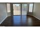 Bright living room showcasing wood-look floors and sliding glass doors to backyard at 24638 N 65Th Ave, Glendale, AZ 85310