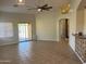 Open-concept living room featuring tile floors, sliding glass door and ceiling fan at 24638 N 65Th Ave, Glendale, AZ 85310