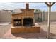 Outdoor fireplace with tiled base and firewood storage at 24638 N 65Th Ave, Glendale, AZ 85310
