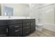 Bathroom features a dark wood vanity with dual sinks, plus a shower and tub combo at 2663 S Equestrian Dr # 106, Gilbert, AZ 85295