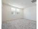 Sunlit bedroom featuring neutral carpeting and two windows that flood the space with natural light at 2663 S Equestrian Dr # 106, Gilbert, AZ 85295