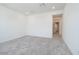 A cozy, carpeted bedroom bathed in light with views to the hall at 2663 S Equestrian Dr # 106, Gilbert, AZ 85295