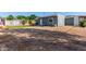 Home's backyard features gravel, a patio, and artificial turf at 340 E Harwell Rd, Gilbert, AZ 85234