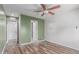 Bedroom featuring ceiling fan, wood-look flooring, and ensuite bathroom at 340 E Harwell Rd, Gilbert, AZ 85234