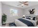 Bedroom with plant, neutral colors, ceiling fan, and a large window at 340 E Harwell Rd, Gilbert, AZ 85234