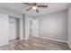 Bedroom with ceiling fan, sliding closet door, and wood-look flooring at 340 E Harwell Rd, Gilbert, AZ 85234