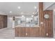 Spacious open kitchen with a granite countertop island, breakfast bar, and stainless steel appliances at 340 E Harwell Rd, Gilbert, AZ 85234
