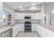 Well-lit kitchen featuring stainless steel appliances, gray countertops, and white cabinets at 340 E Harwell Rd, Gilbert, AZ 85234