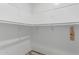 Walk-in closet interior featuring white walls, light fixture, and closet rod at 340 E Harwell Rd, Gilbert, AZ 85234