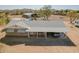 Aerial view of the house, featuring a grey roof, covered parking, desert landscaping, and a view of distant mountains at 35844 N 12Th St, Phoenix, AZ 85086