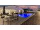 Spacious backyard featuring a pool, gravel, covered patio with dining set, and ample space for entertaining at 36070 N Quiros Dr, San Tan Valley, AZ 85143