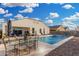 Backyard pool with a patio featuring a dining table and chairs, perfect for outdoor gatherings and relaxation at 36070 N Quiros Dr, San Tan Valley, AZ 85143