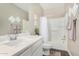 Bathroom features a white vanity, toilet, and shower/tub combo with white tiling and neutral walls at 36070 N Quiros Dr, San Tan Valley, AZ 85143