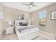Bright bedroom features neutral walls, ceiling fan, and a bright window at 36070 N Quiros Dr, San Tan Valley, AZ 85143