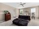 Bedroom with neutral color scheme, ceiling fan, and lounge chairs at 36070 N Quiros Dr, San Tan Valley, AZ 85143