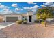 Charming single-story home featuring a well-manicured yard, and inviting front entrance at 36070 N Quiros Dr, San Tan Valley, AZ 85143