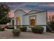 Inviting front entrance, complemented by lovely landscaping, and neutral stucco at 36070 N Quiros Dr, San Tan Valley, AZ 85143