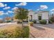 Charming single-story home featuring a well-manicured front yard with desert landscaping and vibrant green shrubbery at 36070 N Quiros Dr, San Tan Valley, AZ 85143