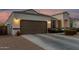 Lovely two-car garage with beautiful stucco, exterior lighting, and well-maintained driveway at 36070 N Quiros Dr, San Tan Valley, AZ 85143