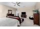 Spacious main bedroom with ceiling fan, TV and decorative accents at 36070 N Quiros Dr, San Tan Valley, AZ 85143