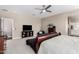 Large bedroom with sitting area, ceiling fan and neutral decor at 36070 N Quiros Dr, San Tan Valley, AZ 85143