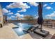 Backyard pool featuring lounge chairs, an umbrella, and a water feature, offering a refreshing outdoor oasis at 36070 N Quiros Dr, San Tan Valley, AZ 85143