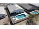 Aerial view of a beautiful backyard pool and patio area with lounge chairs, dining table, and a well-maintained privacy fence at 36070 N Quiros Dr, San Tan Valley, AZ 85143