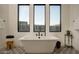 Bright bathroom features a modern soaking tub with black fixtures and mountain views at 37200 N Cave Creek Rd # 1035, Scottsdale, AZ 85262