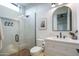 This modern bathroom features white tiling, glass shower, and a vanity with storage at 37200 N Cave Creek Rd # 1035, Scottsdale, AZ 85262