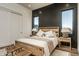 Bedroom with wood accent wall, neutral decor, a cozy rug, and natural light at 37200 N Cave Creek Rd # 1035, Scottsdale, AZ 85262