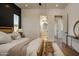 Bedroom featuring hardwood floors, neutral decor, and ensuite bathroom at 37200 N Cave Creek Rd # 1035, Scottsdale, AZ 85262