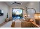 Elegant bedroom with a cozy seating area and views of a beautiful outdoor pool at 37200 N Cave Creek Rd # 1035, Scottsdale, AZ 85262