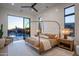 Stylish bedroom with a four-poster bed and seamless access to a beautiful outdoor pool at 37200 N Cave Creek Rd # 1035, Scottsdale, AZ 85262