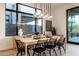 Bright dining area features modern lighting, a wooden table with seating for eight, and a large window at 37200 N Cave Creek Rd # 1035, Scottsdale, AZ 85262