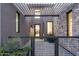 Welcoming entrance featuring a metal pergola, stone accents, and a glimpse of the home's interior at 37200 N Cave Creek Rd # 1035, Scottsdale, AZ 85262