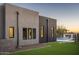 Modern home exterior complemented by green grass and a sleek pool with outdoor fireplace at 37200 N Cave Creek Rd # 1035, Scottsdale, AZ 85262