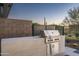 Outdoor grill area featuring a built-in grill with spacious countertop and desert landscaping at 37200 N Cave Creek Rd # 1035, Scottsdale, AZ 85262