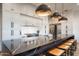 Elegant kitchen features a spacious island with seating, modern appliances, and white cabinetry at 37200 N Cave Creek Rd # 1035, Scottsdale, AZ 85262