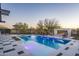 Stunning pool featuring a baja shelf and a modern outdoor fireplace with cozy seating at 37200 N Cave Creek Rd # 1035, Scottsdale, AZ 85262
