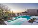 Beautiful pool featuring a baja shelf and lush desert landscaping at sunset at 37200 N Cave Creek Rd # 1035, Scottsdale, AZ 85262