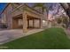 Back patio boasting a ceiling fan, and a view of the well-kept synthetic grass and fenced-in yard at 3777 E Latham Ct, Gilbert, AZ 85297