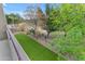 Large, fenced backyard featuring synthetic grass and mature trees at 3777 E Latham Ct, Gilbert, AZ 85297