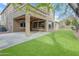 Exterior view of backyard with artificial turf and covered patio at 3777 E Latham Ct, Gilbert, AZ 85297