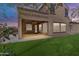 An outdoor living space featuring a covered patio, turf lawn, and privacy, great for entertaining and relaxing at 3777 E Latham Ct, Gilbert, AZ 85297