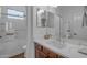 Modern bathroom with a glass-enclosed shower, vanity with a white countertop, and wood cabinets at 3777 E Latham Ct, Gilbert, AZ 85297
