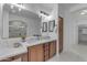 Elegant bathroom with a double sink vanity, large mirror, and a view of the walk-in shower at 3777 E Latham Ct, Gilbert, AZ 85297