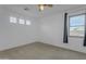 Minimalist bedroom with neutral carpet, a ceiling fan, and a window with blue curtains for natural light at 3777 E Latham Ct, Gilbert, AZ 85297