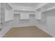 Walk-in closet featuring custom shelving and ample storage space for a luxurious living experience at 3777 E Latham Ct, Gilbert, AZ 85297